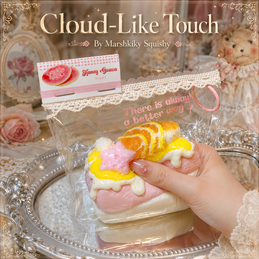 Female hand squeezing the soft Marshkiky cake squishy to show its cloud-like touch.