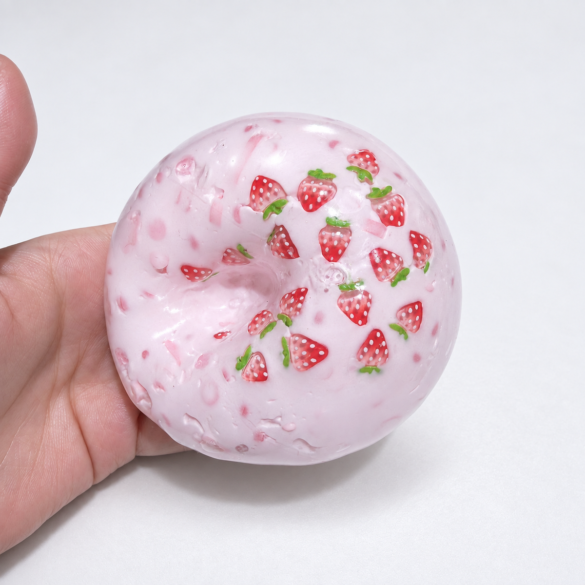 Translucent pink sensory squishy ball with visible resin strawberry-shaped pieces; Strawberry Milkshake handmade sensory squishy ball, product photo 2