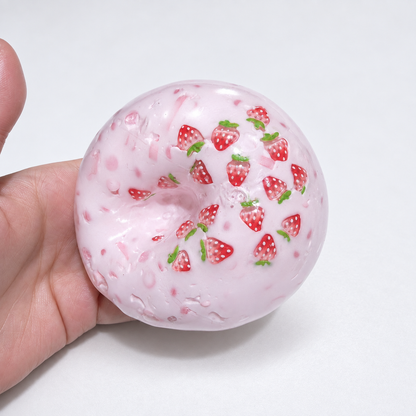 Translucent pink sensory squishy ball with visible resin strawberry-shaped pieces; Strawberry Milkshake handmade sensory squishy ball, product photo 2
