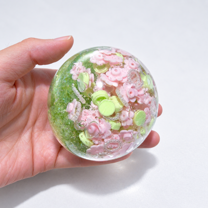 Green-tinted sensory squishy ball with resin pink flower-shaped pieces and small decorative beads; Spring Blossom handmade sensory squishy ball, product photo 4