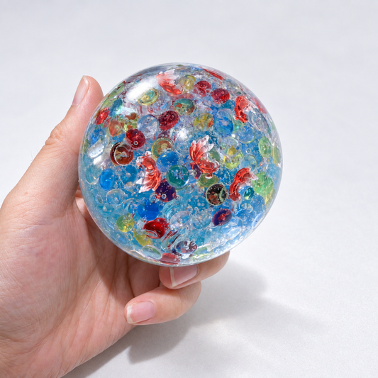 Blue translucent sensory squishy ball with colorful resin fish-shaped details; Floating Light Fish handmade sensory squishy ball, product photo 2