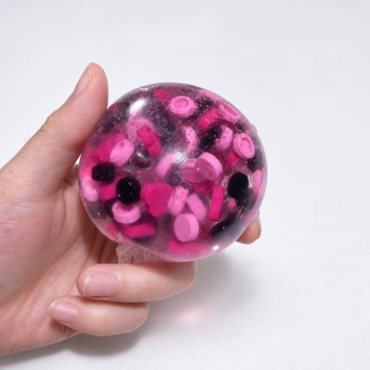 Translucent pink sensory squishy ball with contrasting dark and pink resin decorative pieces; Pink Black Sweetheart handmade sensory squishy ball, product photo 1