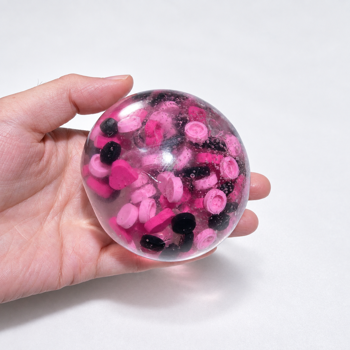 Translucent pink sensory squishy ball with contrasting dark and pink resin decorative pieces; Pink Black Sweetheart handmade sensory squishy ball, product photo 2