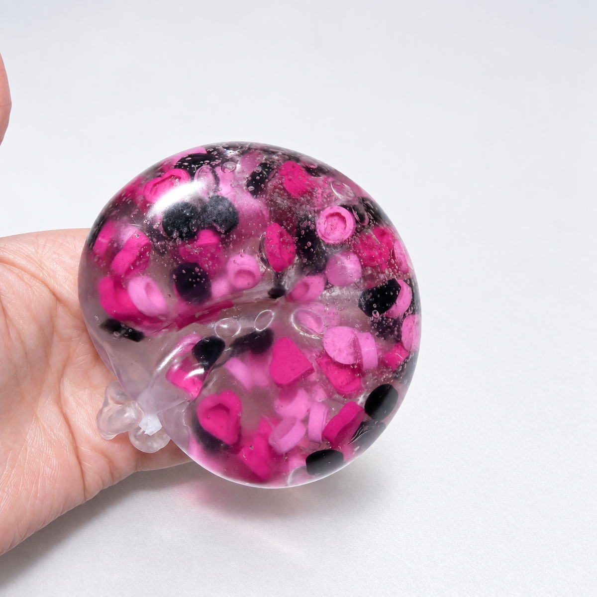 Translucent pink sensory squishy ball with contrasting dark and pink resin decorative pieces; Pink Black Sweetheart handmade sensory squishy ball, product photo 3