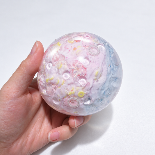Pale pastel sensory squishy ball with delicate resin inclusions in pink, blue, and lavender tones; Pink Blue Dream handmade sensory squishy ball, product photo 1