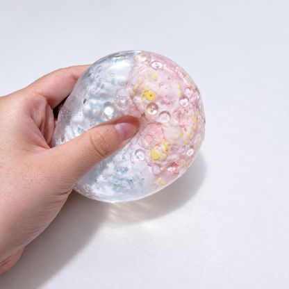 Pale pastel sensory squishy ball with delicate resin inclusions in pink, blue, and lavender tones; Pink Blue Dream handmade sensory squishy ball, product photo 3