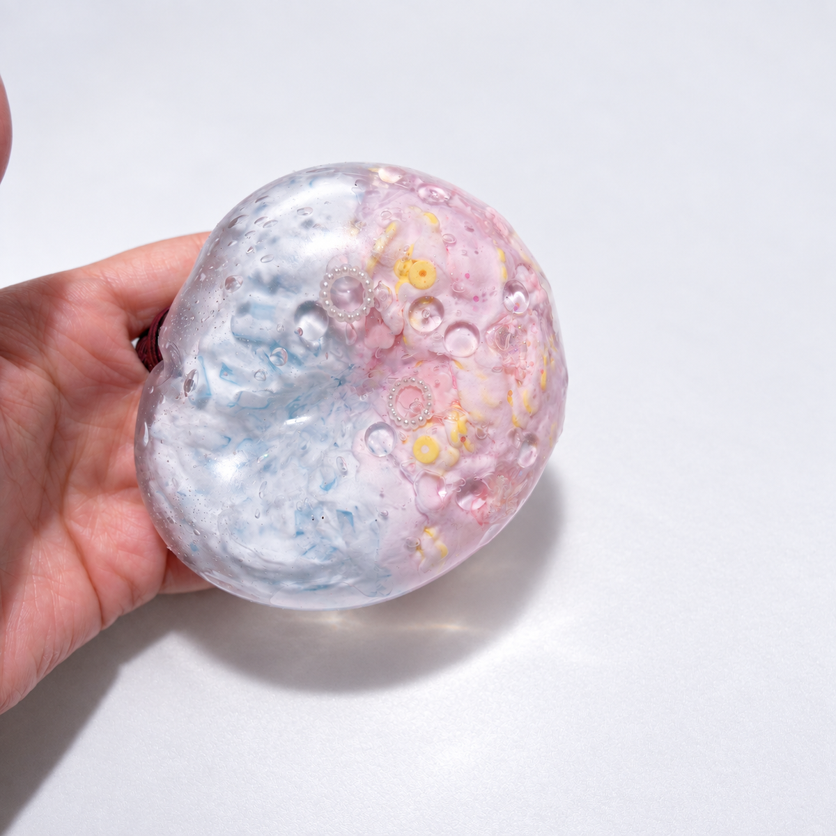 Pale pastel sensory squishy ball with delicate resin inclusions in pink, blue, and lavender tones; Pink Blue Dream handmade sensory squishy ball, product photo 4