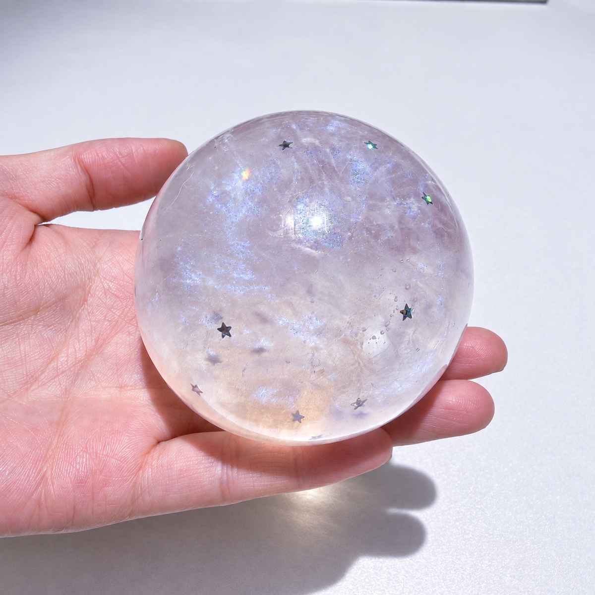 Translucent sensory squishy ball with resin star details and pearlescent shimmer; Glass Galaxy handmade sensory squishy ball, product photo 1