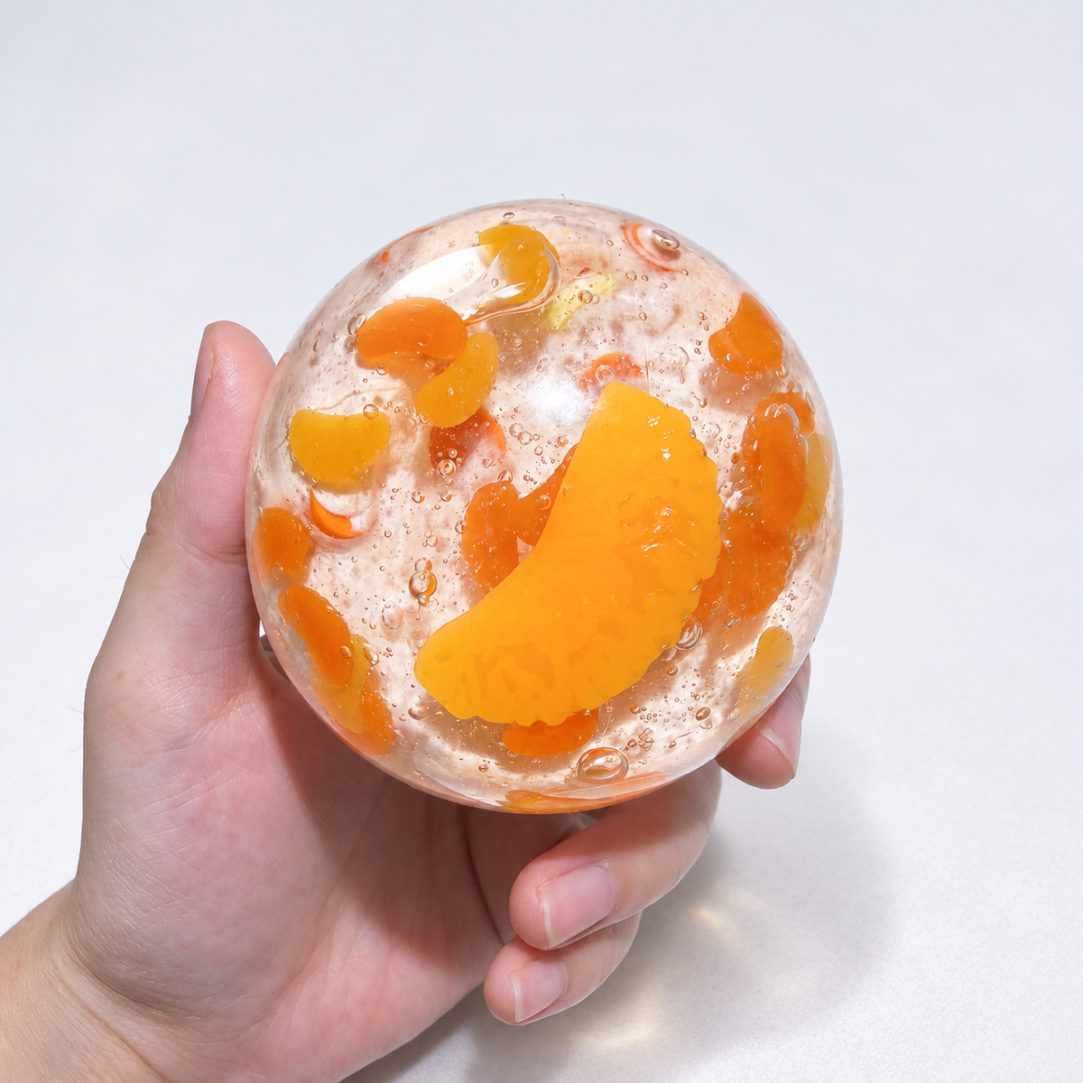Warm orange sensory squishy ball with resin citrus slice details; Sunset Orange Sea handmade sensory squishy ball, product photo 1