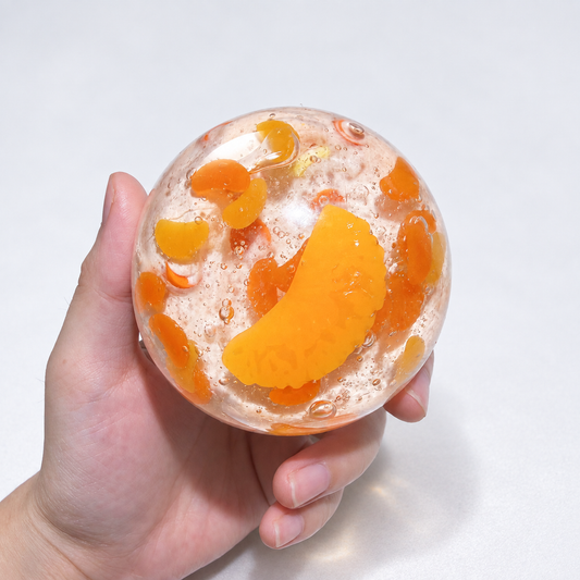 Warm orange sensory squishy ball with resin citrus slice details; Sunset Orange Sea handmade sensory squishy ball, product photo 1