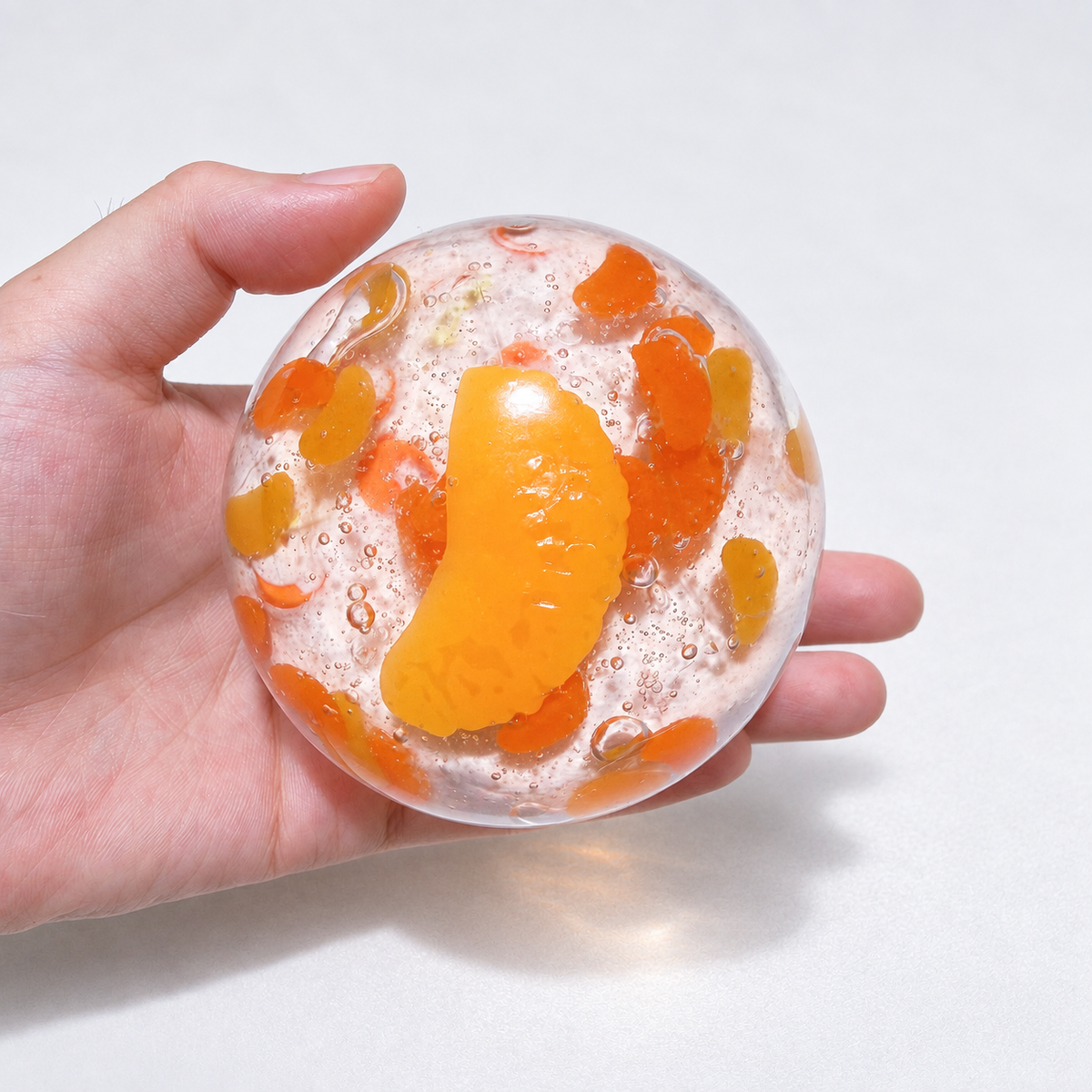 Warm orange sensory squishy ball with resin citrus slice details; Sunset Orange Sea handmade sensory squishy ball, product photo 3