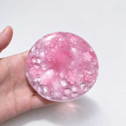 Pink translucent sensory squishy ball with resin sakura blossom details and beads; Sakura Dream handmade sensory squishy ball, product photo 1