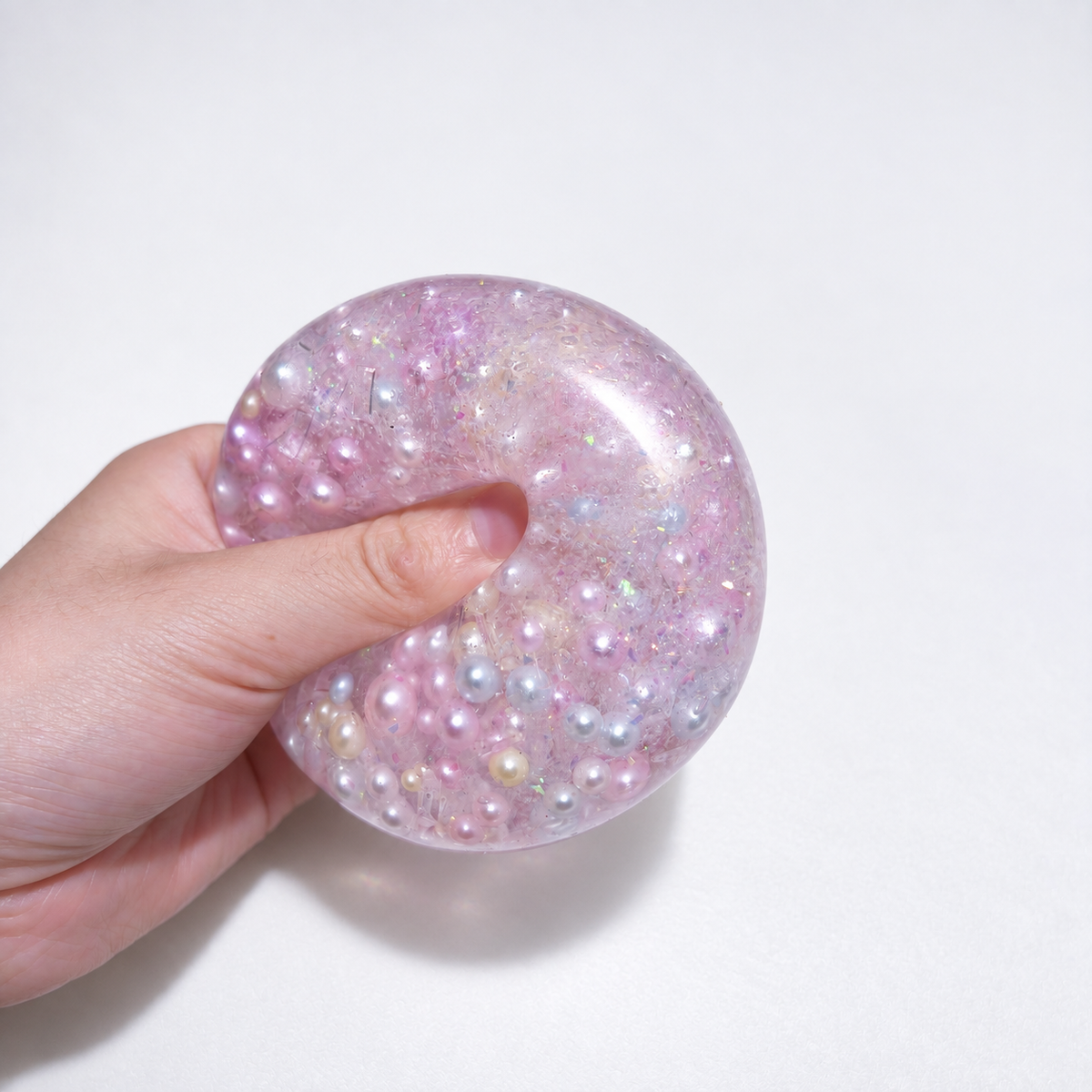 Pink translucent sensory squishy ball with resin pearl-like beads and iridescent details; Mermaid Pink Pearl handmade sensory squishy ball, product photo 3
