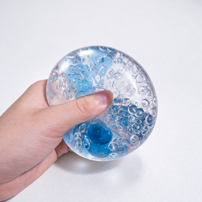 Clear pale-blue sensory squishy ball with blue and transparent resin bead details; Azure Water World handmade sensory squishy ball, product photo 3