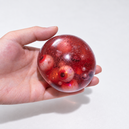 Close view of several eyeball details inside the red squishy ball