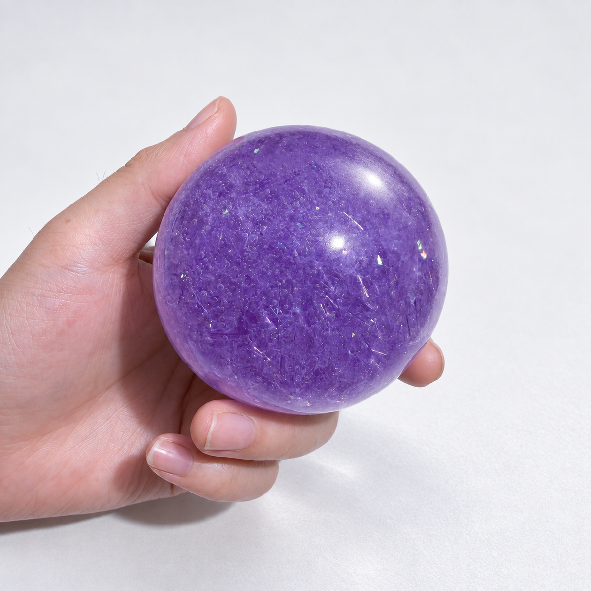Purple ball with fine transparent decorative strips visible inside